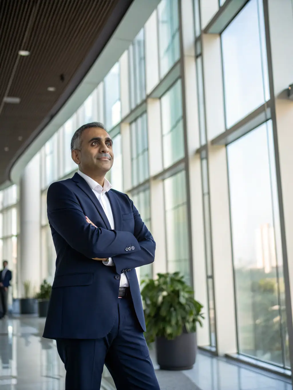 A professional business coach in a sharp suit, looking directly at the camera with a confident and trustworthy expression, set against a backdrop of a modern office with financial charts subtly displayed.